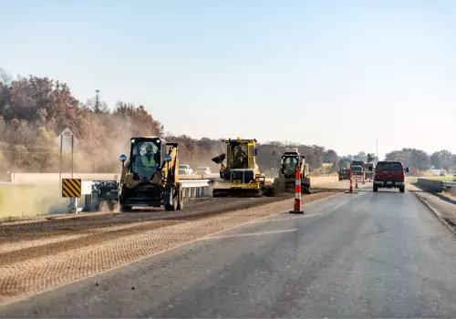 A crew is seen laying asphalt. Hoerr's Blacktop & Sealcoating is an Asphalt Contractor Near Me