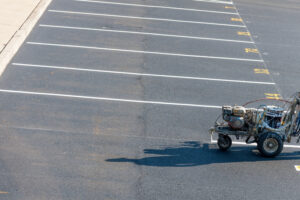 A striping machine works on a parking lot as part of Parking Lot Striping and Sealcoating Galesburg IL services